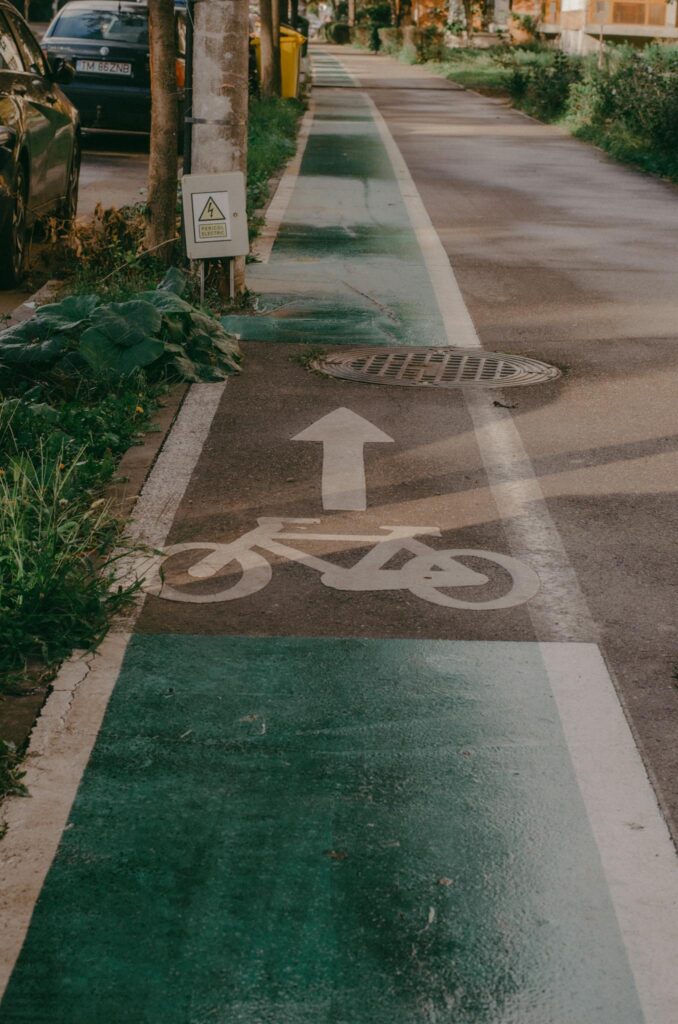 A bicycle lane with directional arrow on a city street, offering guidance for cyclists.