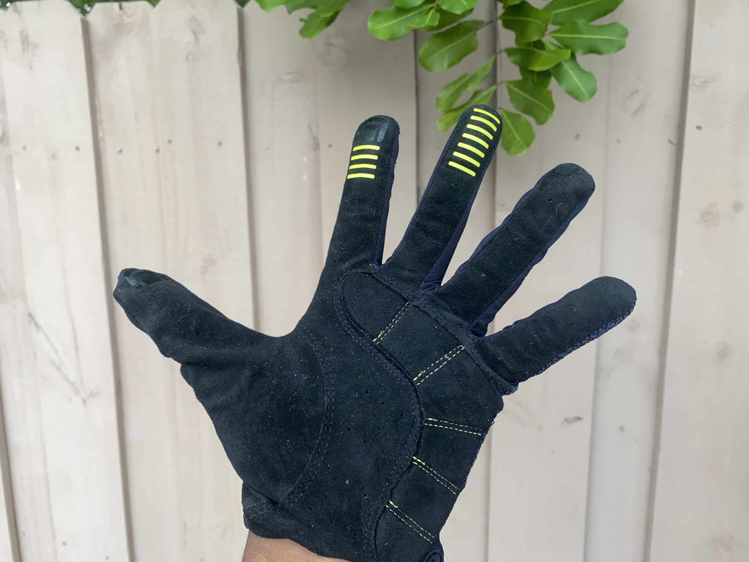 Black gardening glove with yellow grip accents, ideal for outdoor yard work and plant care.